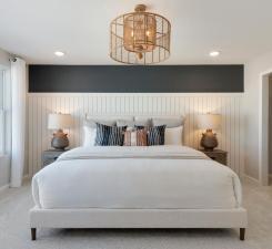 Welcome to the Primary Bedroom. The Ashton bedroom is a calming oasis and the perfect retreat at the end of the day! Photo of model home.