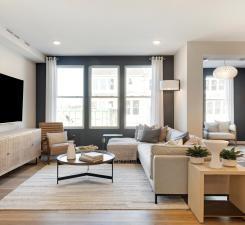 Soaring windows drench the living room in natural light! Photo of model home.
