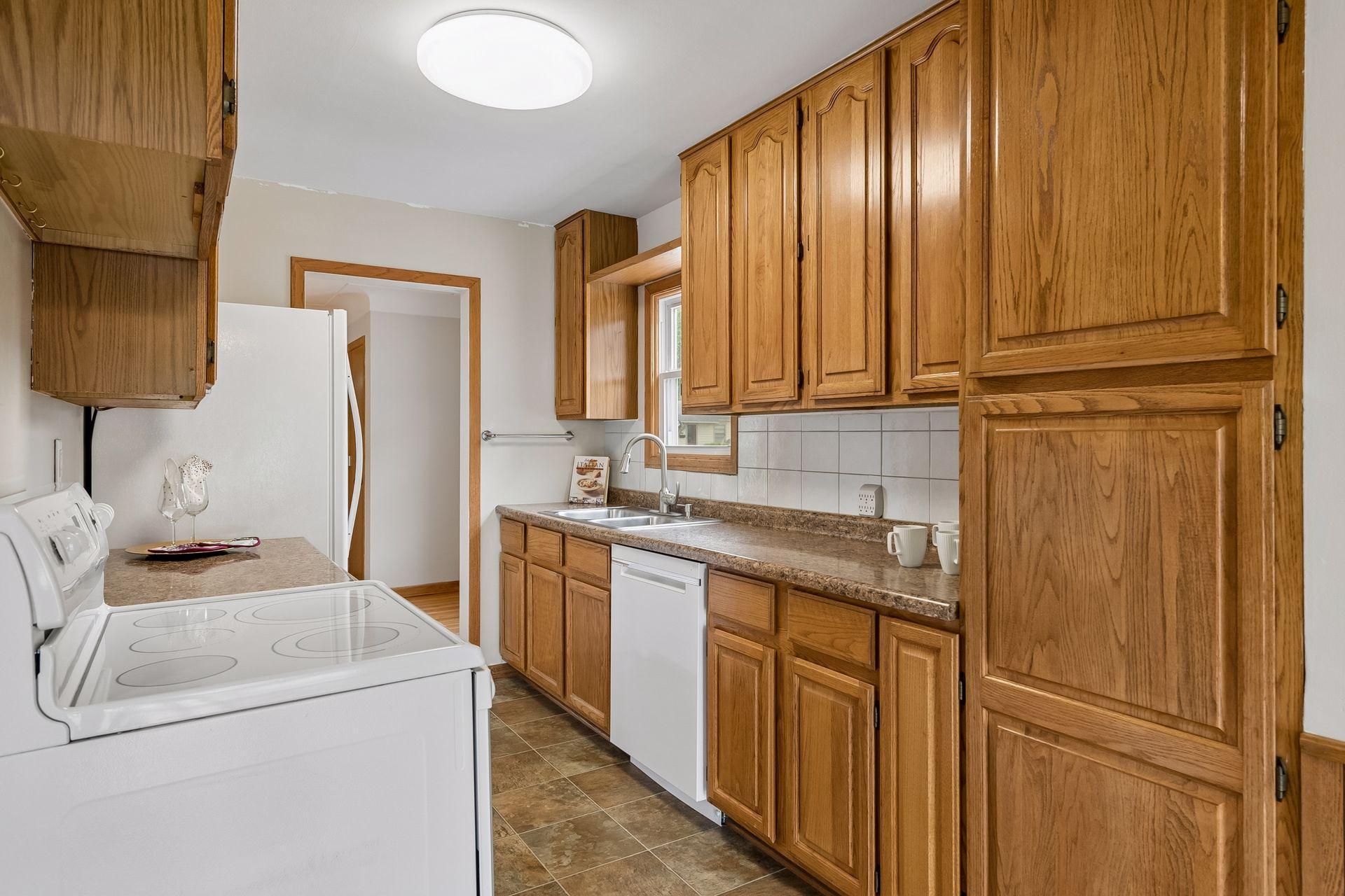 Spacious kitchen features ample cabinetry and newer appliances