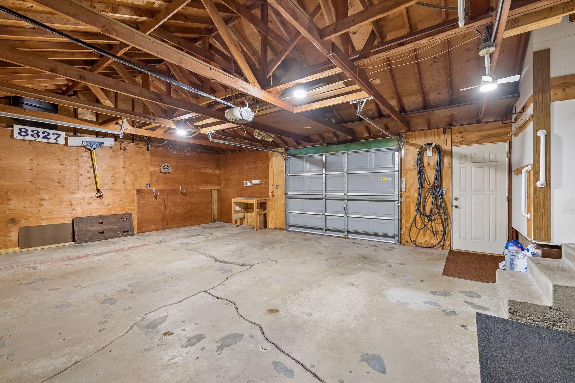 Over sized garage features front and rear garage doors, work and storage space
