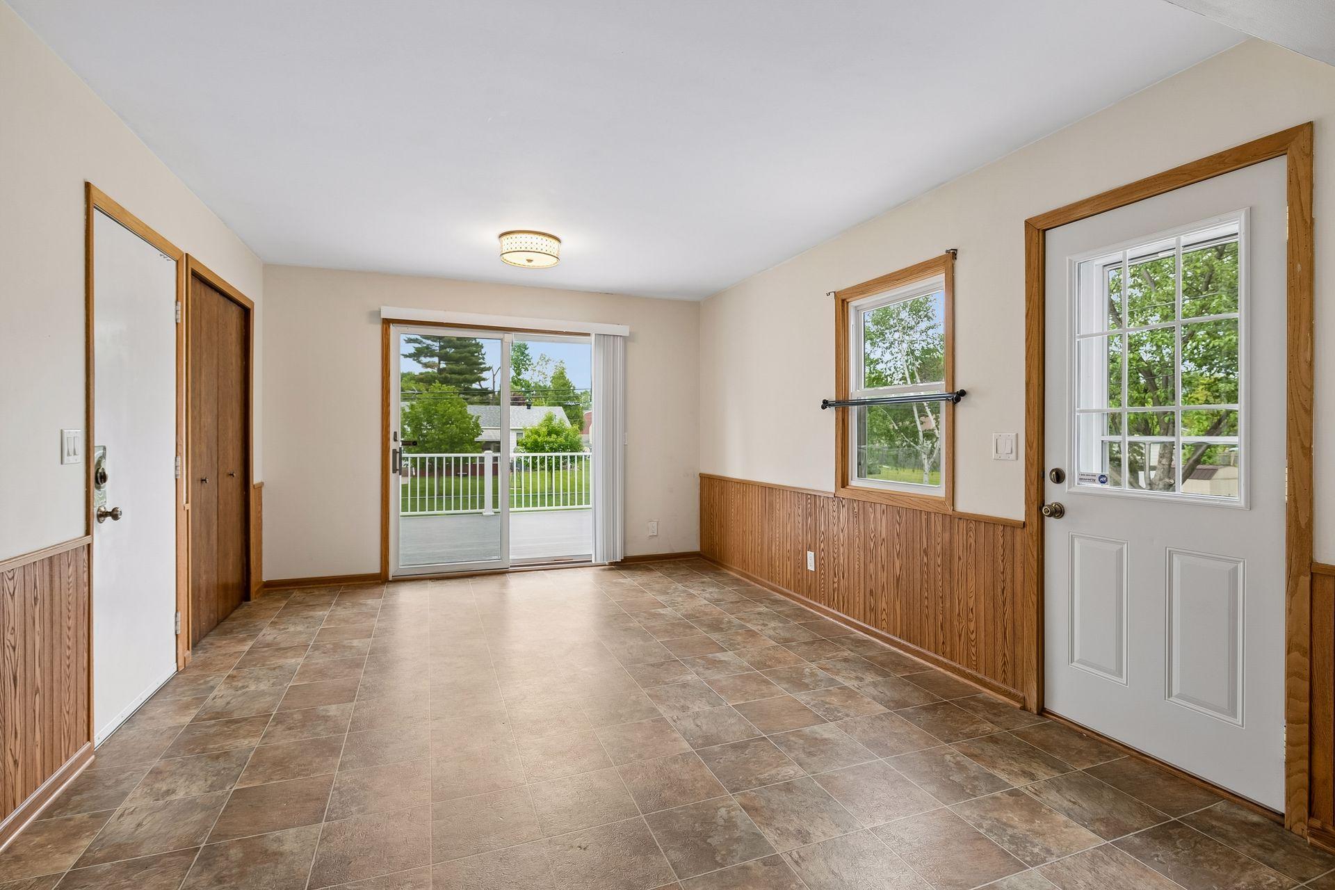 Main floor flex space has patio doors to deck and access to garage