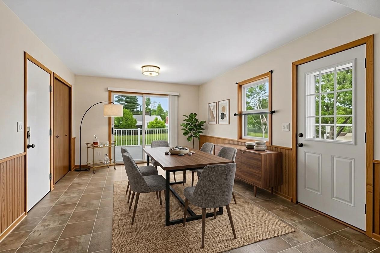 Main floor addition currently used as a dining room. Virtually staged