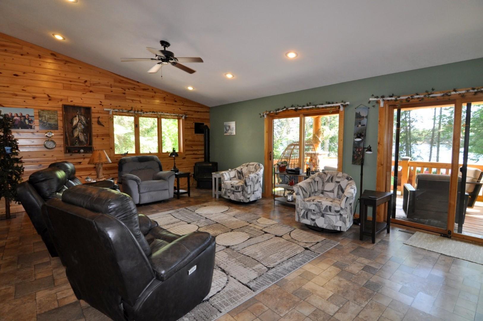 Living Room with vaulted ceilings and access to lakeside covered deck