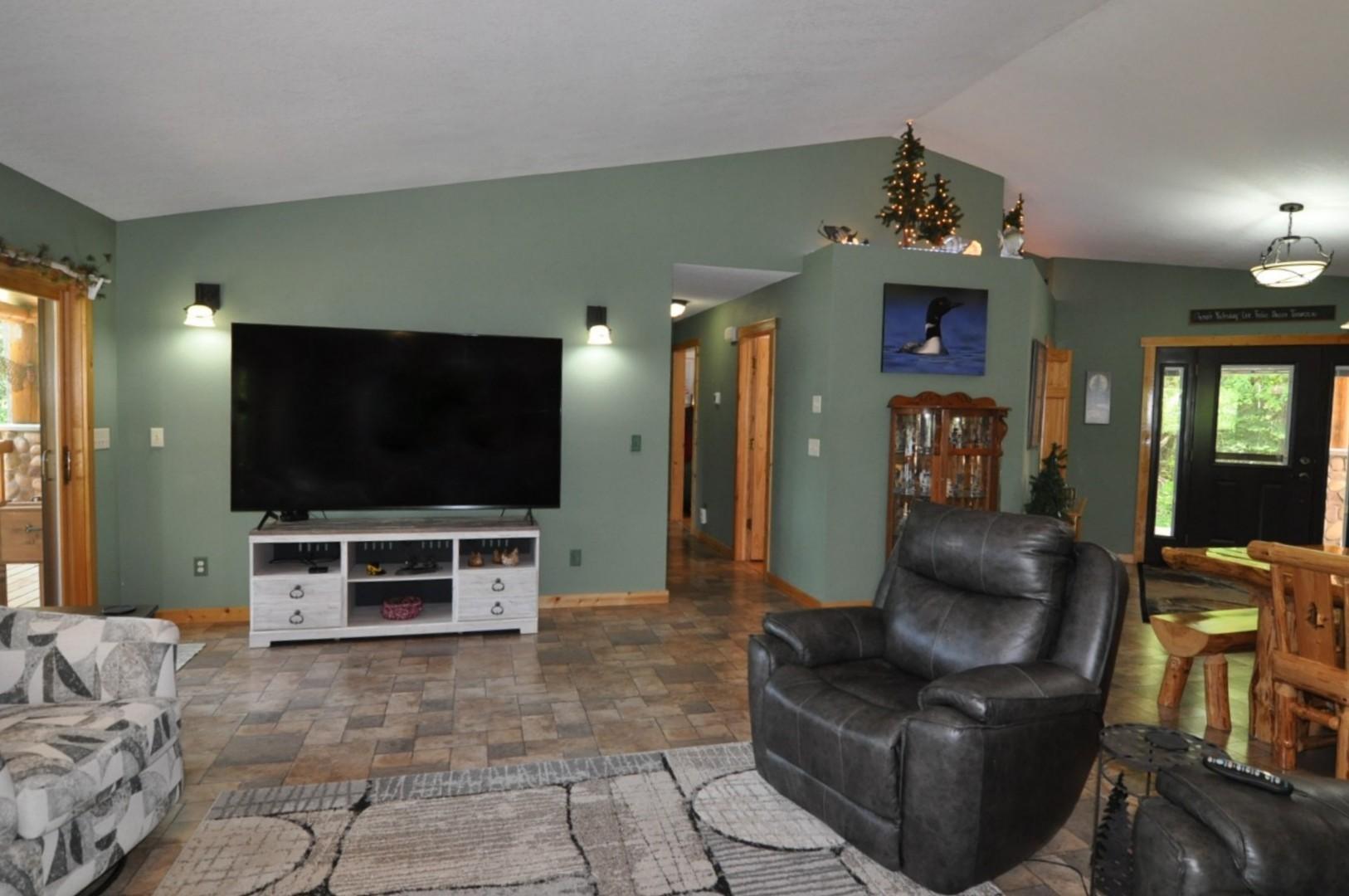 Living room with access down the hall to primary bedroom, office, and hall bathroom