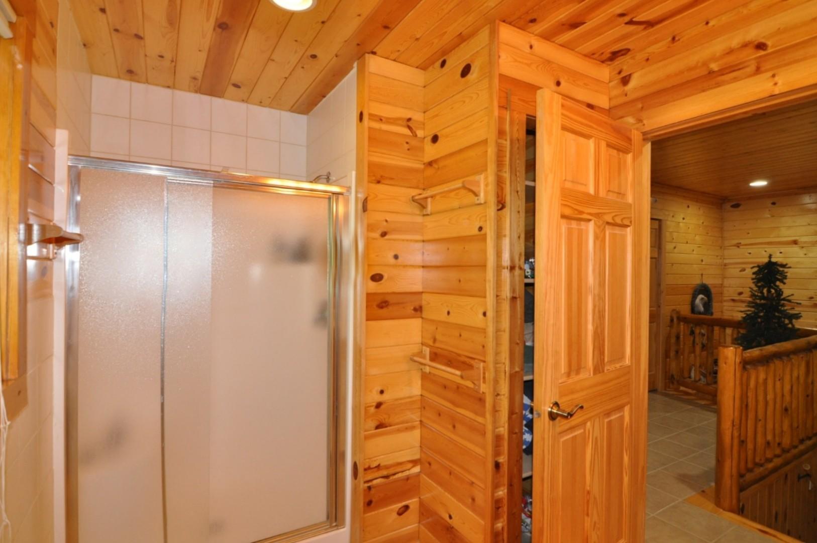 Walk-in shower and storage behind door