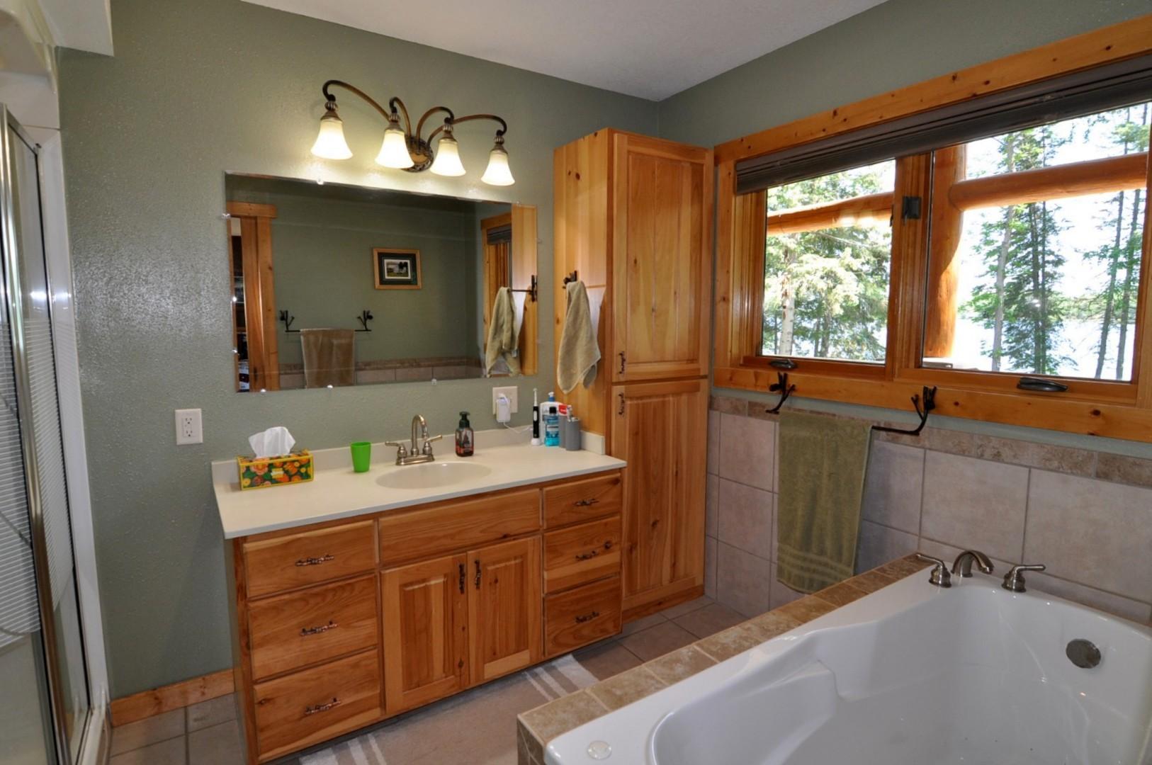 Private primary bath with lakeview, separate tub, and shower