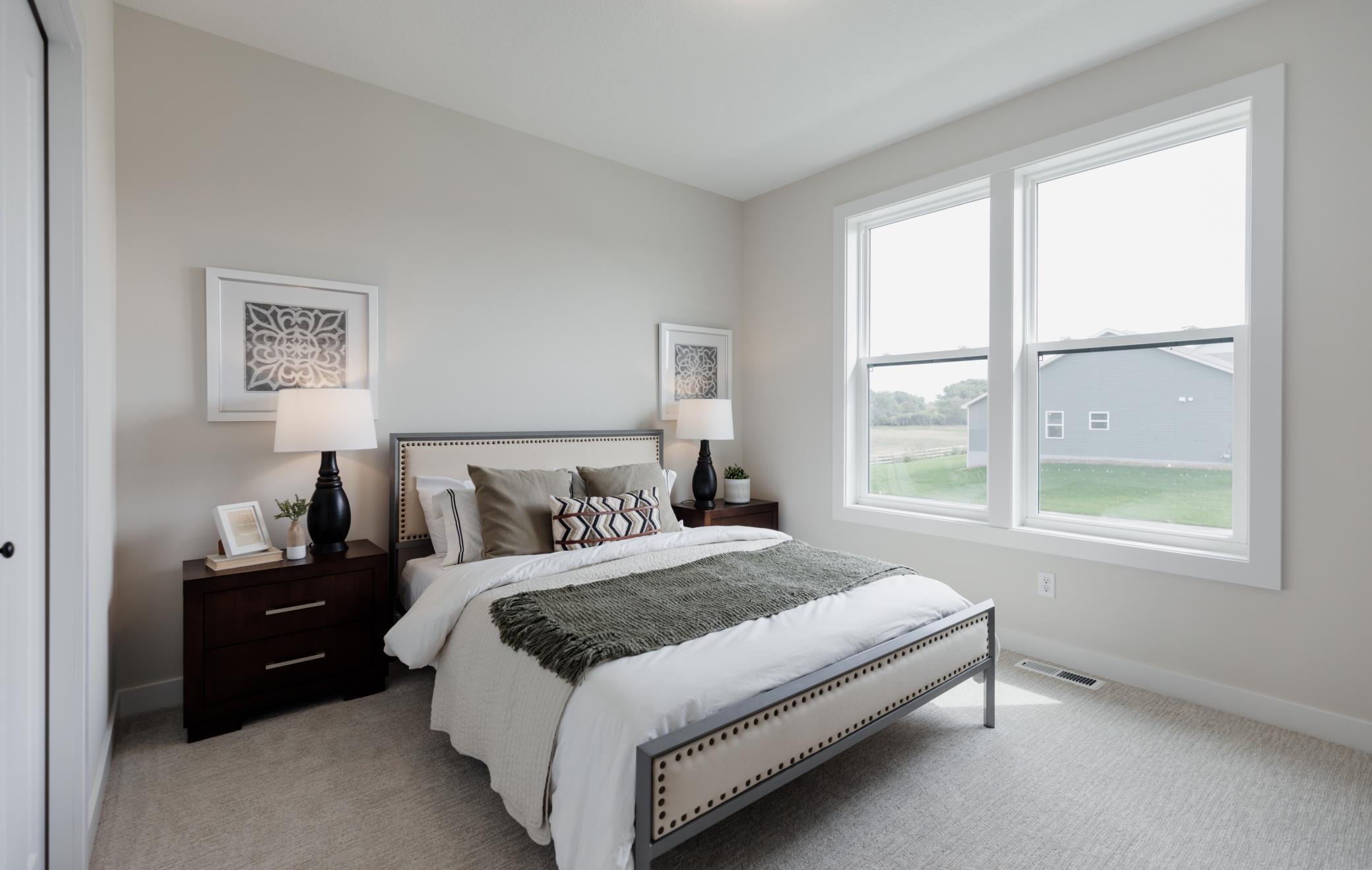 Secondary main level bedroom. *Photo of similar home with the same layout.