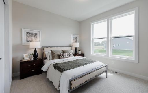 Secondary main level bedroom. *Photo of similar home with the same layout.