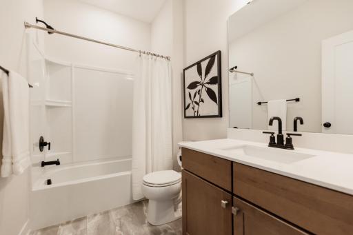 Main floor full bathroom. *Photo of similar home with the same layout.
