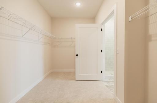 The primary bedroom walk-in closet. *Photo of similar home with the same layout.