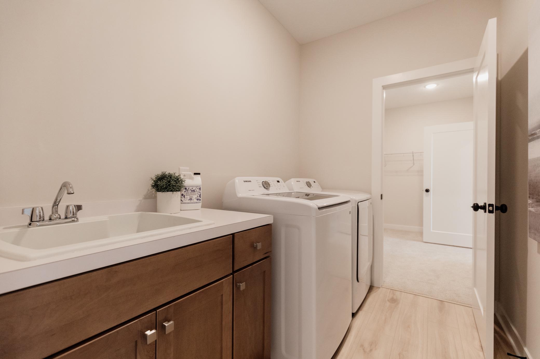 Main level laundry room. *Photo of similar home with the same layout.