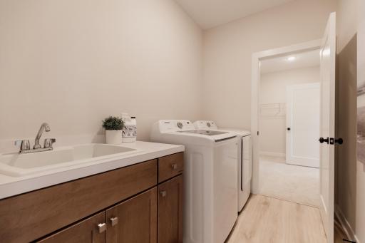 Main level laundry room. *Photo of similar home with the same layout.