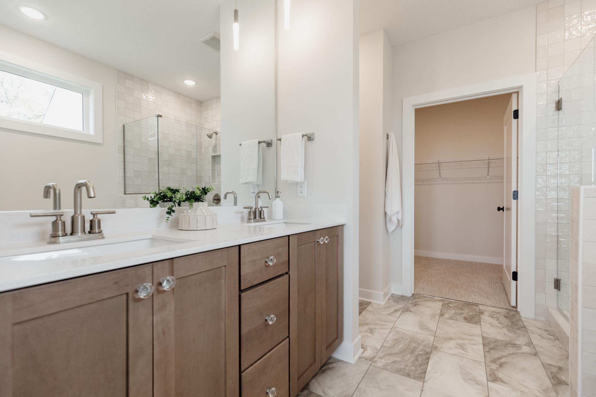 The primary bedroom ensuite. *Photo of similar home with the same layout.