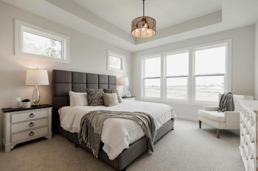 The primary bedroom. *Photo of similar home with the same layout.