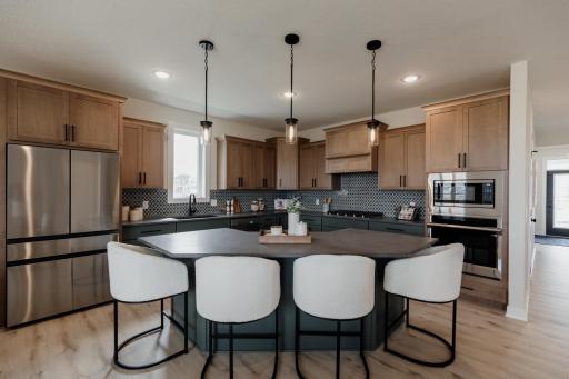 The gourmet kitchen. *Photo of similar home with the same layout.