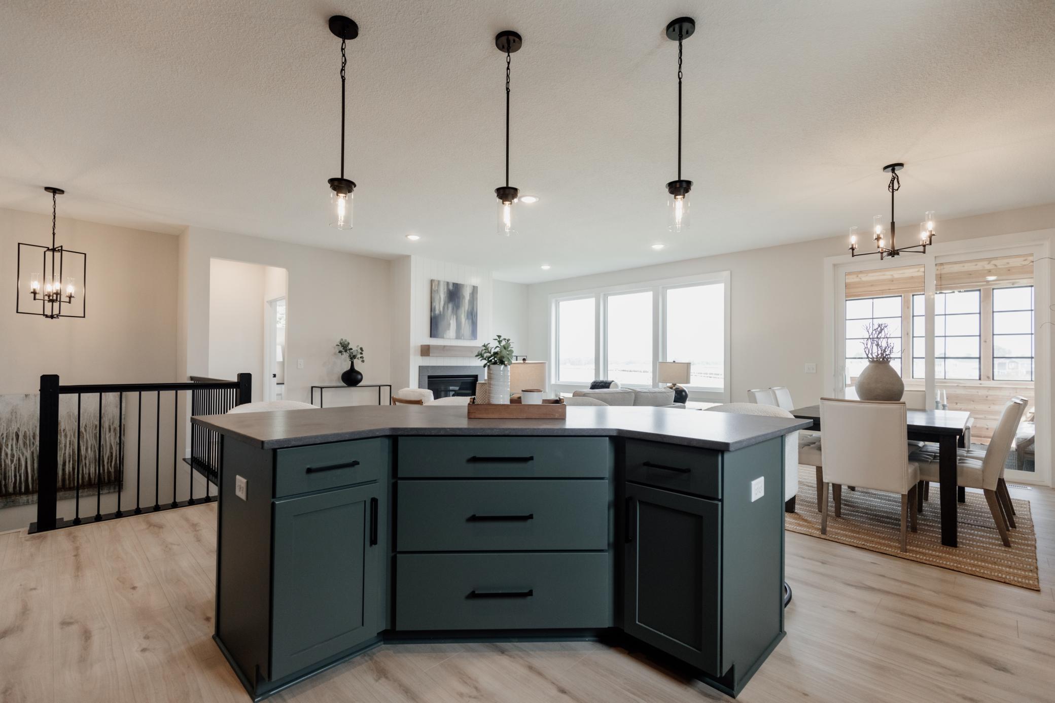 The gourmet kitchen oversized island. *Photo of similar home with the same layout.
