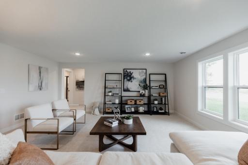 Lower level family room. *Photo of similar home with the same layout.