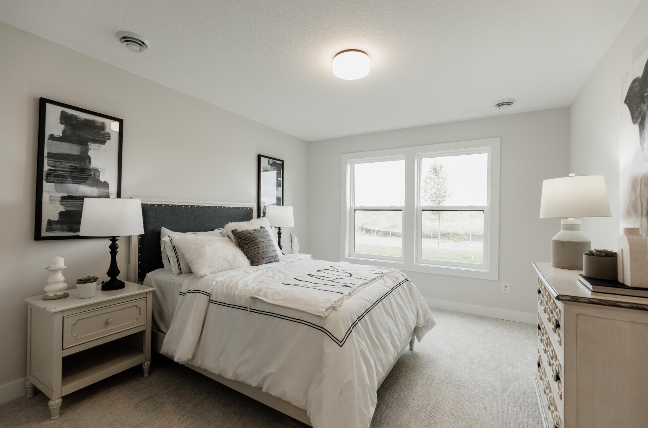 Secondary lower level bedroom. *Photo of similar home with the same layout.