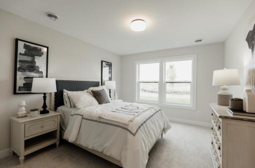 Secondary lower level bedroom. *Photo of similar home with the same layout.