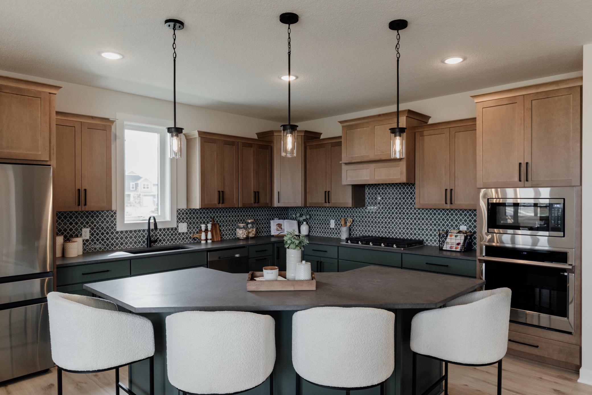 The gourmet kitchen. *Photo of similar home with the same layout.