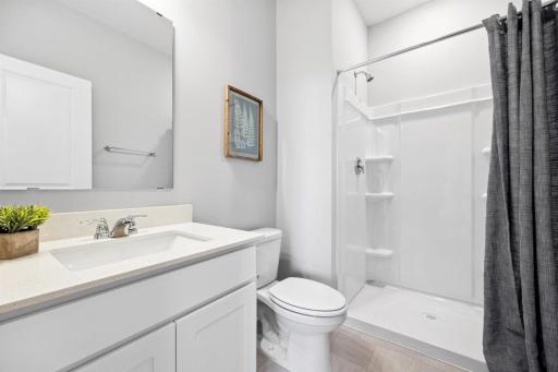 Main Floor Bathroom *Photo is of a past model home, finishes, selections, layout to vary.