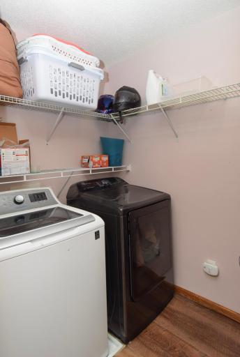 Lots of shelving and extra storage in the laundry room