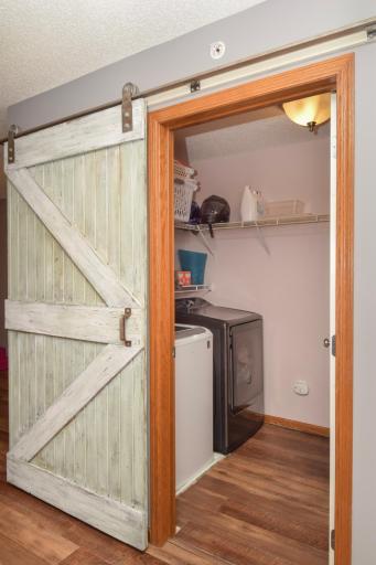 Laundry room conveniently located at the top of the stairs with a decorative barn door to close it off.