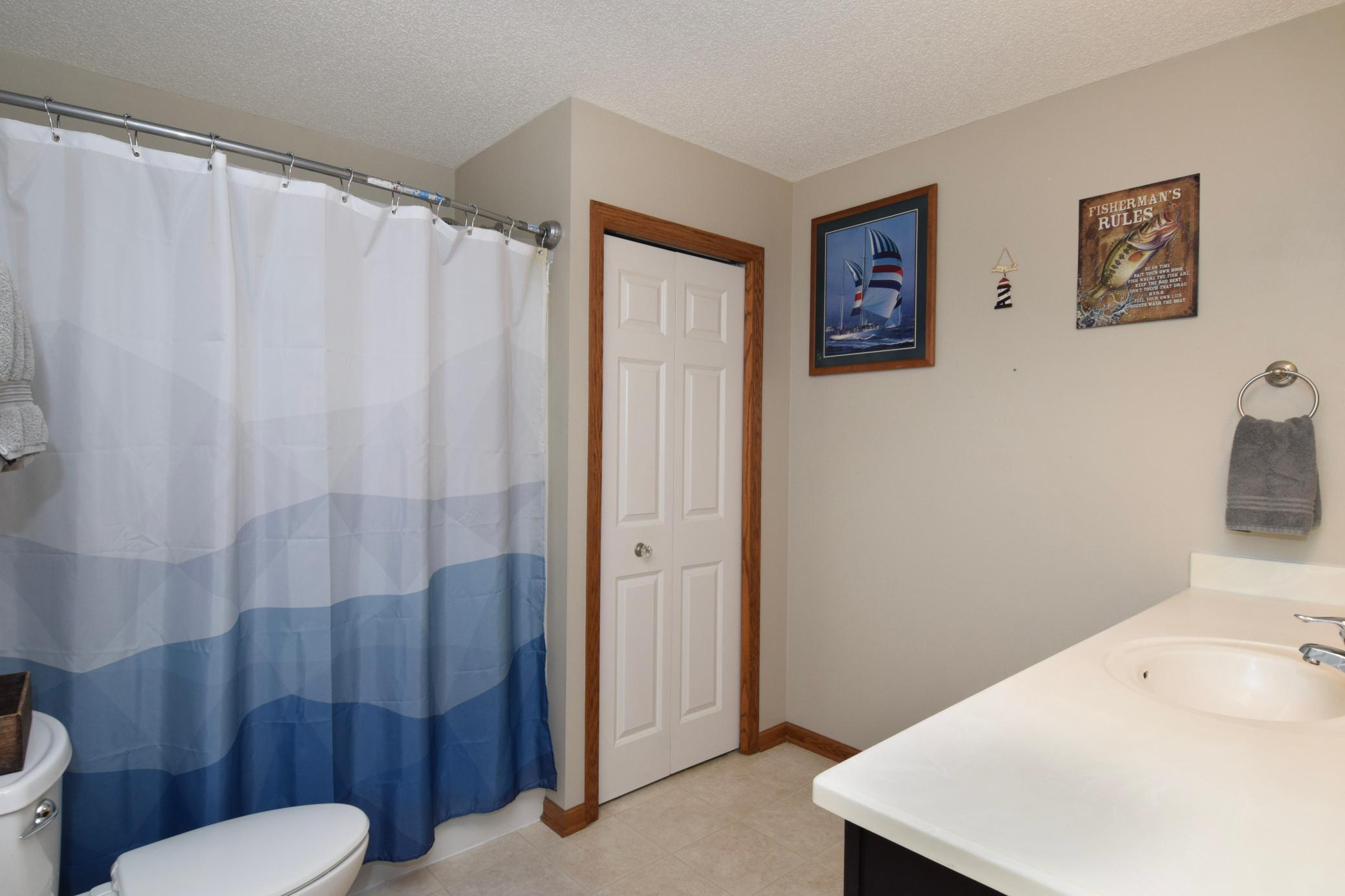 Primary full bathroom with additional walkthrough to the main hallway to put clothes in the laundry.