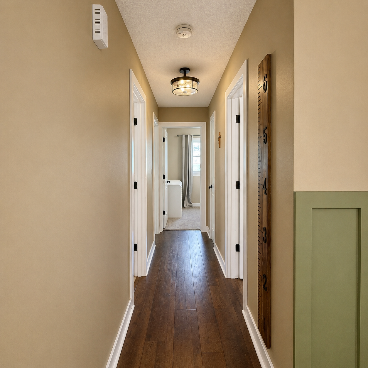 Hallway leads to full bathroom and three bedrooms on the main floor