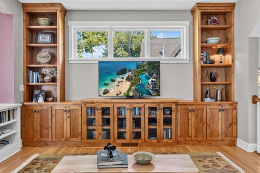 Living Room features built-in alder entertainment cabinet that offers glass doors, storage and open display shelving