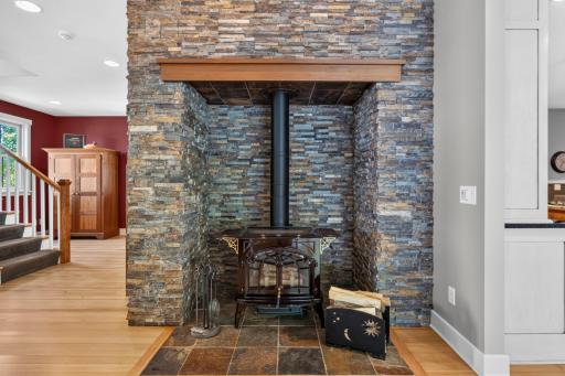Free standing wood burning fireplace with slate stone surround and hearth