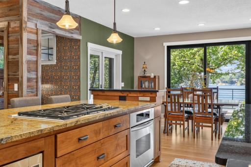 Stainless steel appliances include Amana refrigerator, Wolf 36" gas cooktop, Kitchen Aid wall oven and Bosch dishwasher