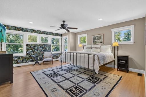 Master Bedroom features newly refinished Douglas fir hardwood flooring and abundance of windows with treetop lake views!