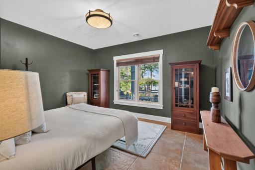 Bedroom 4 features large windows that offer great lakeside views, ceramic tile heated floors and walk-in closet
