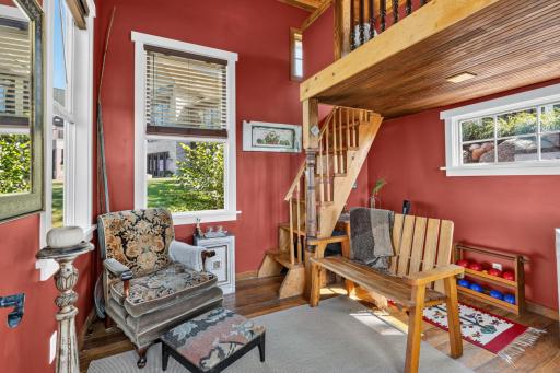 The Lakeside Retreat features full glass French patio doors, decorative stained glass windows, wood paneled walls, lofted area and small wooden deck!