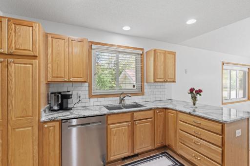 Easy-to-use kitchen featuring an extra-deep sink, abundant cabinet space, and a functional layout designed for both convenience and everyday living.