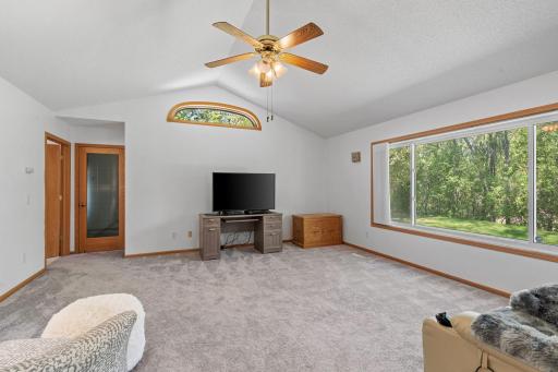Huge picture window with peaceful views overlooking the nature preserve, bringing in natural light and a relaxing outdoor backdrop.