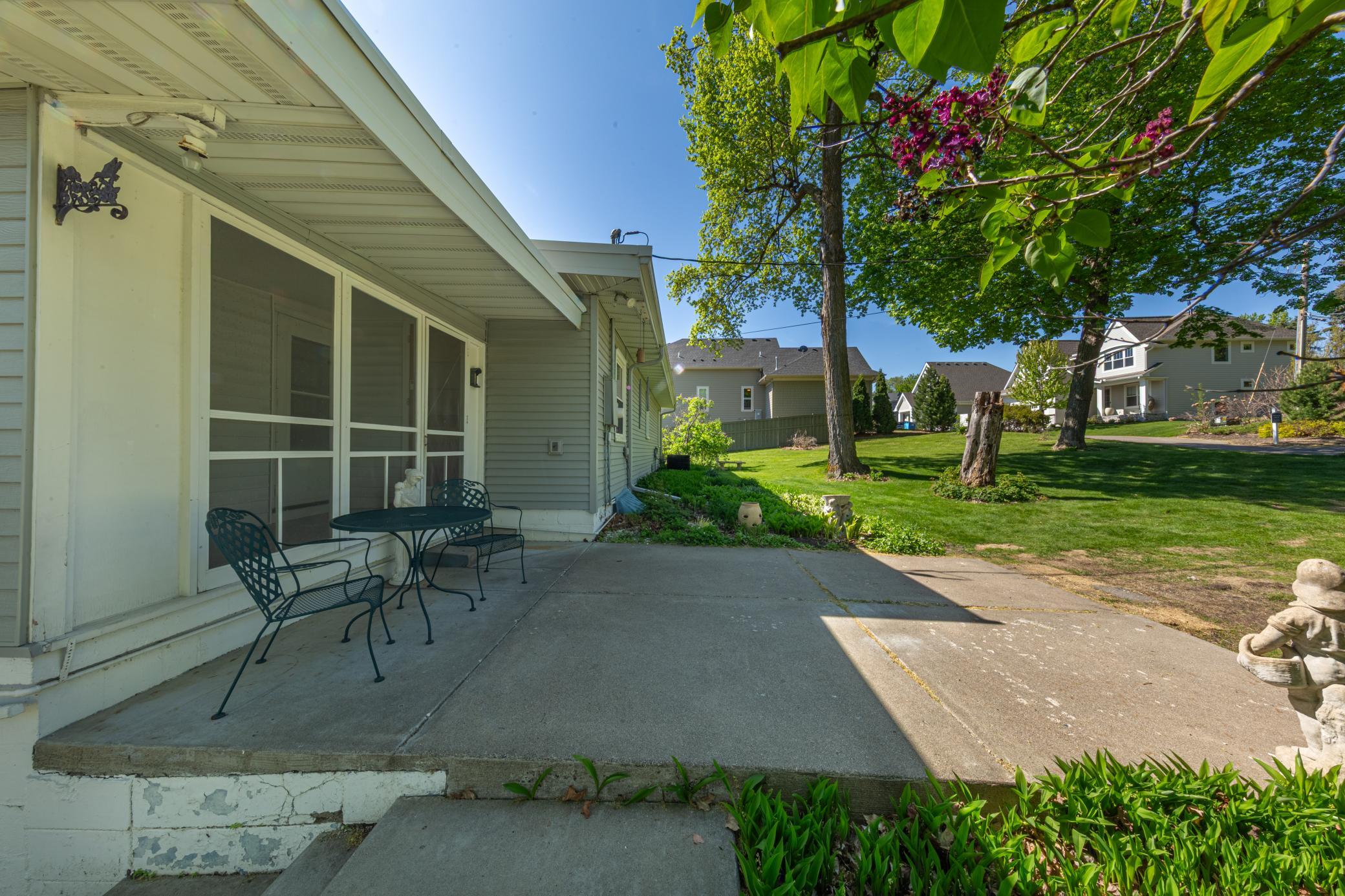 Patio in backyard off of screened in porch