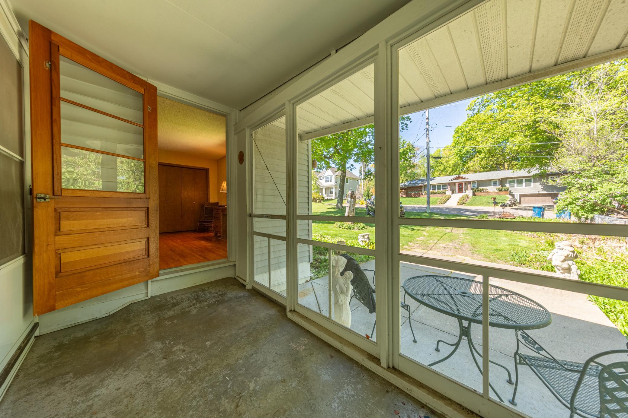 Screened in porch looking out to backyard