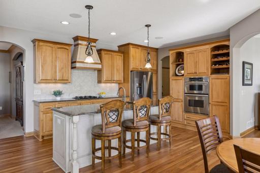 The kitchen is seamlessly open to the main living spaces, with an efficient layout and elevated custom wood finishes