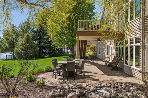 Thoughtfully designed landscaping features distinct seating areas for entertaining, complemented by a serene fountain
