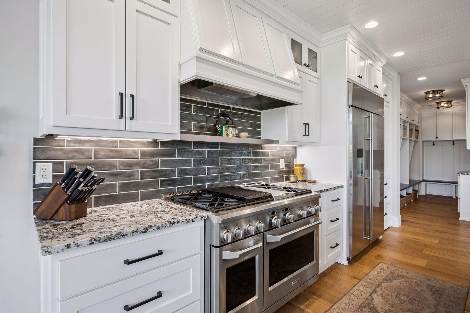 Top-of-the-line appliances include a professional-grade 6-burner gas range with double ovens and a spacious cooktop.