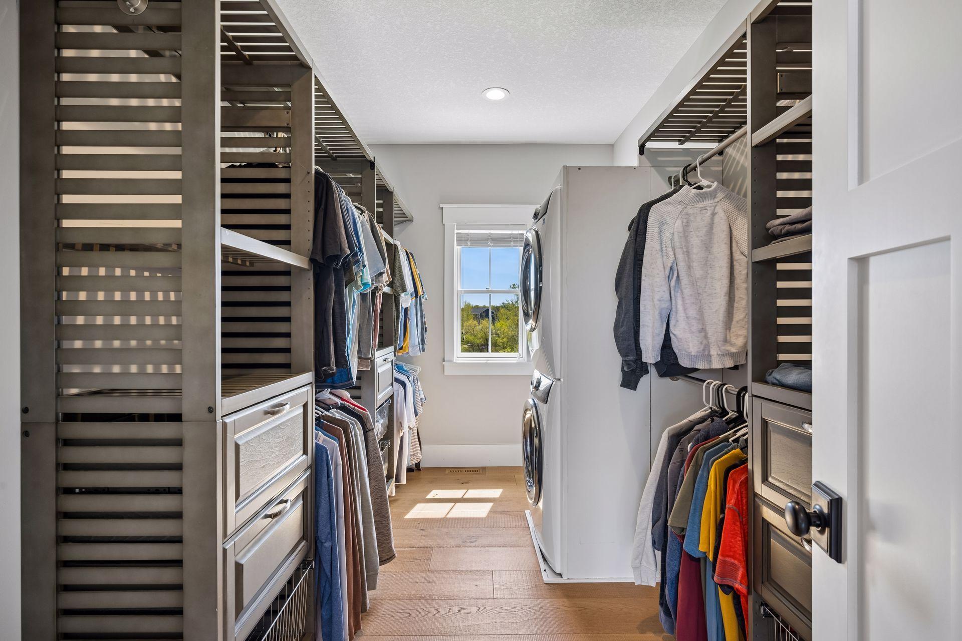 A custom-designed primary closet with a dedicated washer and dryer adds exceptional convenience.