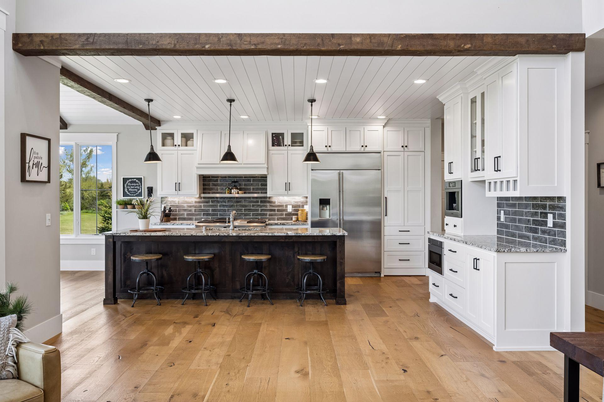 A chef-inspired gourmet kitchen featuring exposed wood beams and elegant shiplap ceilings.