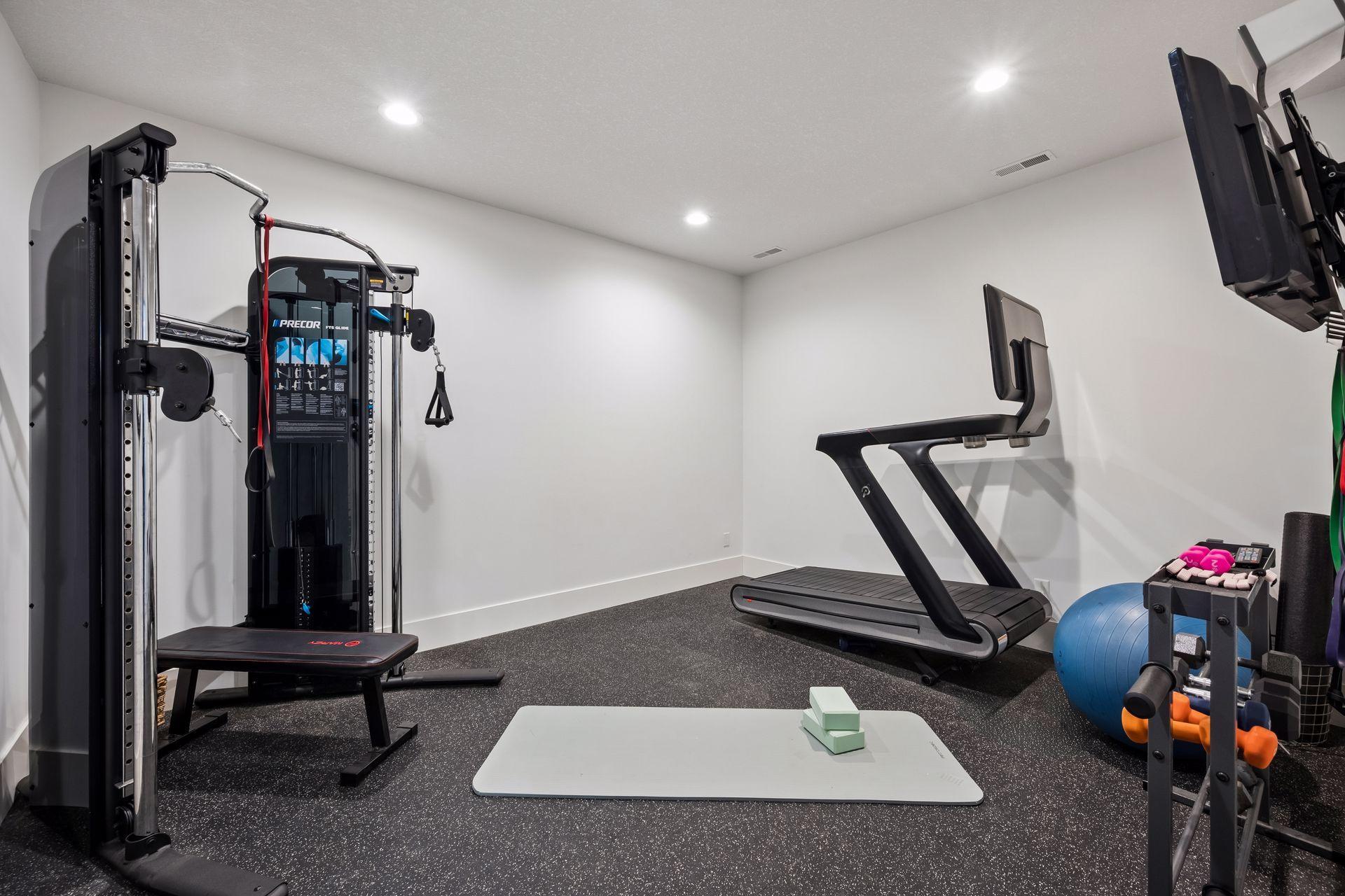 Lower level room currently being used as a home gym.