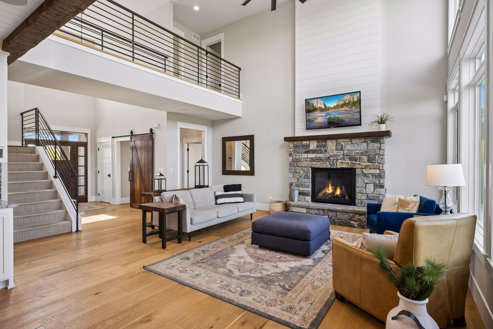 The living room features 2-story ceilings and a stone gas fireplace.