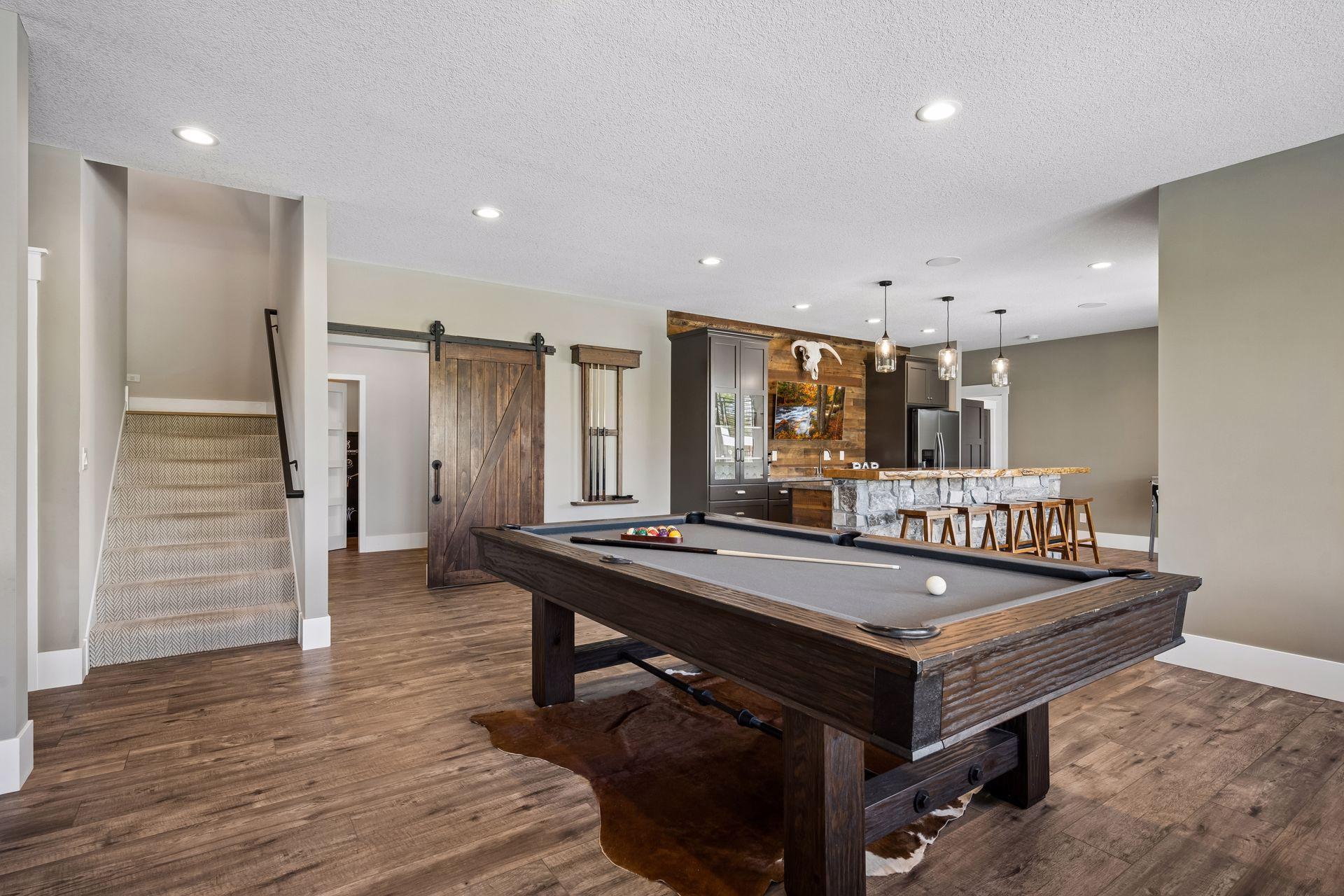 The entertainment space leads to the stunning wet bar, creating the ultimate setting for relaxing and entertaining!