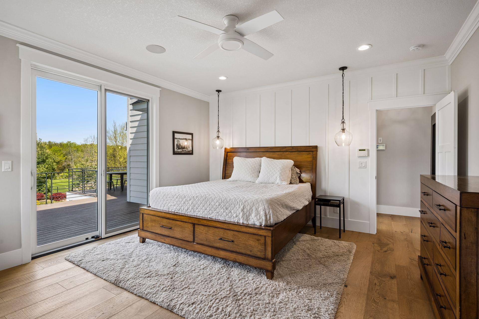 Main floor primary retreat with sliding patio door leading to the deck.