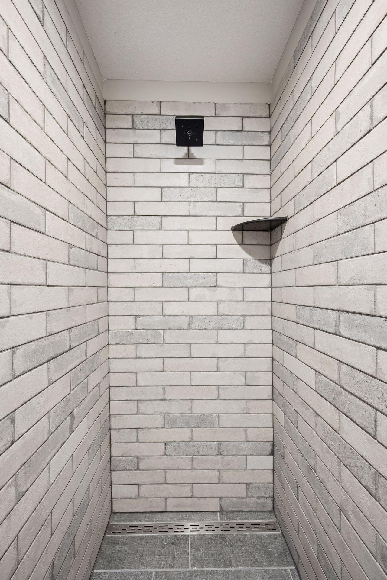 Lower level tile walk-in shower.