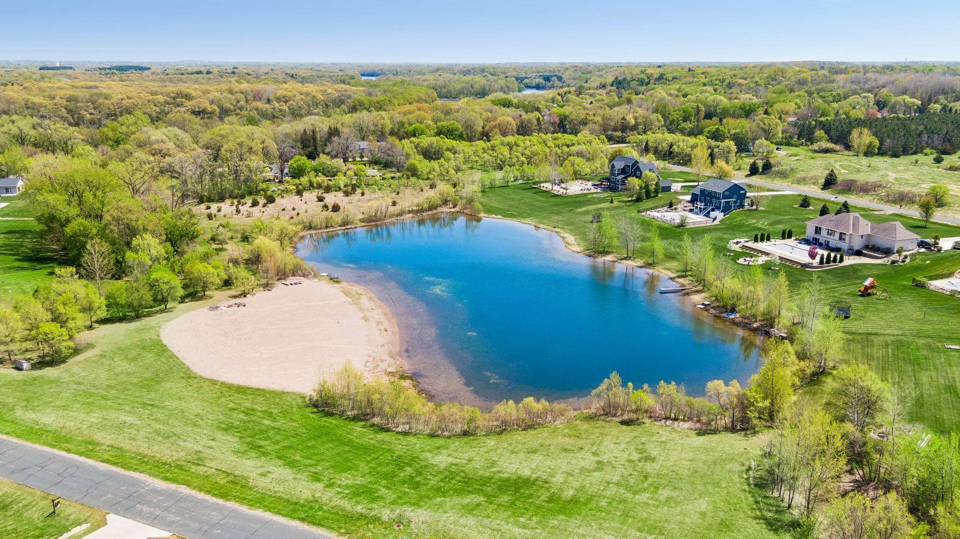 A private man-made lake complete with a sandy beach, dock, and stocked fishing.